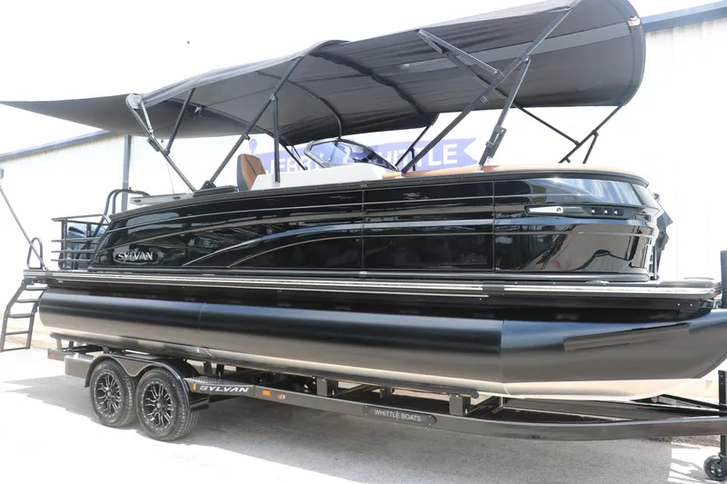 Slide: The Image of 2026 Sylvan G3 DLZ Bar pontoon boat with canopy on trailer, side view. - 4