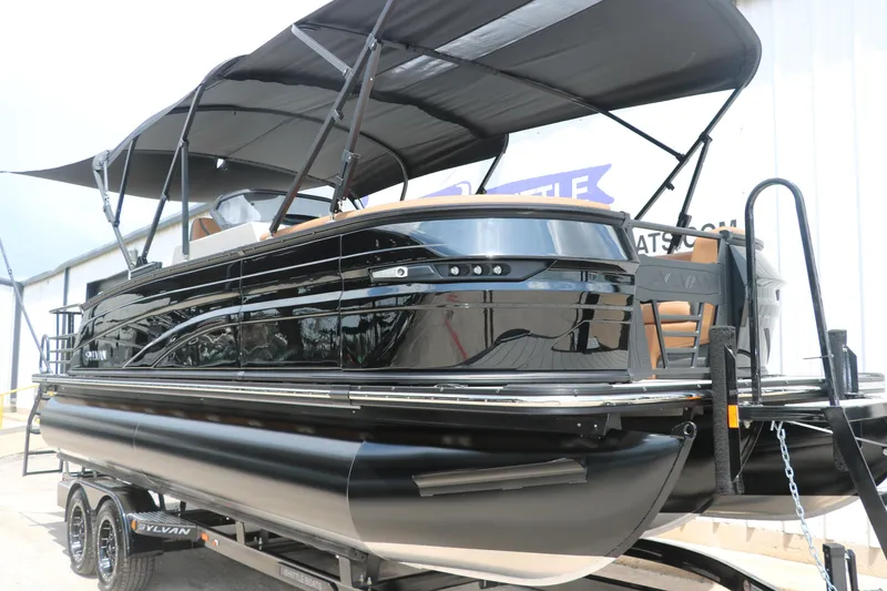 Slide: The Image of 2026 Sylvan G3 DLZ Bar pontoon boat with sleek black design and canopy. - 5