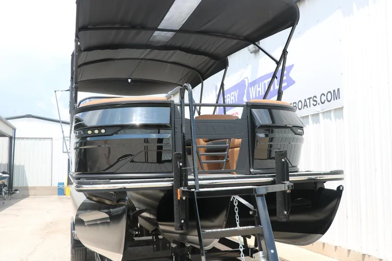 Slide: The Image of 2026 Sylvan G3 DLZ Bar pontoon boat with canopy, displayed outdoors. - 6