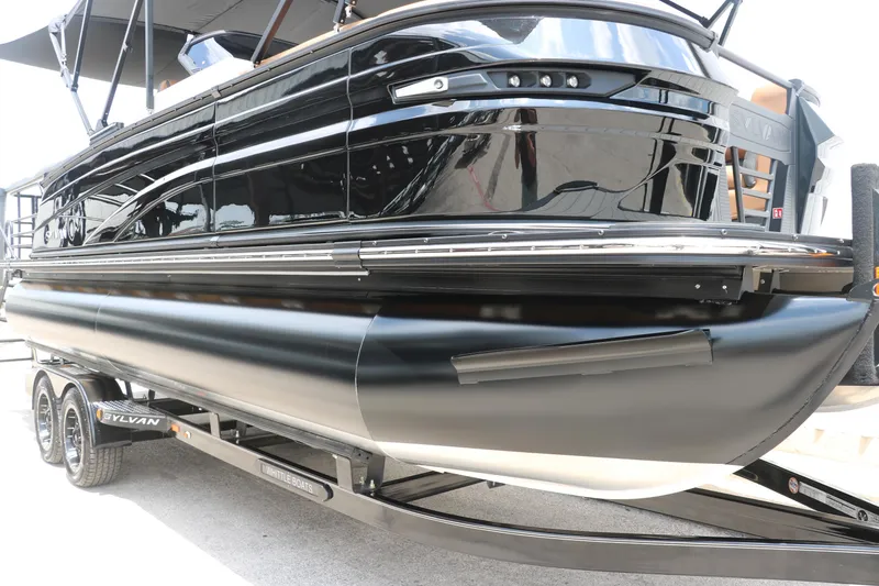Slide: The Image of 2026 Sylvan G3 DLZ Bar pontoon boat on trailer, sleek black design. - 9