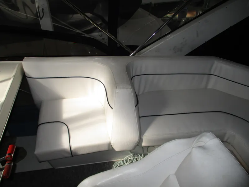 Slide: The Image of Interior seating of 1989 Bayliner 3888 yacht with white upholstery and black trim. - 16