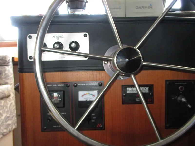 Slide: The Image of Steering wheel and control panel of 1989 Bayliner 3888 boat, featuring Garmin equipment. - 21