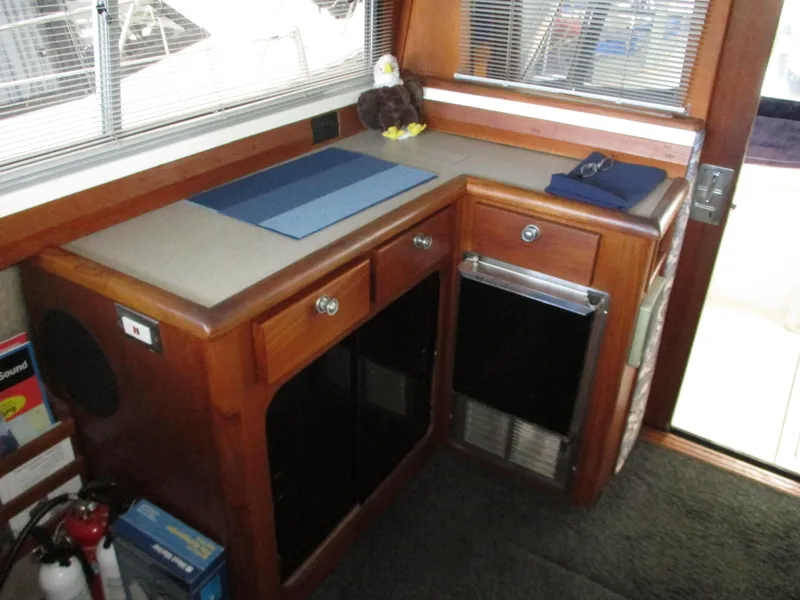Slide: The Image of 1989 Bayliner 3888 yacht interior with wooden cabinetry and countertop accessories. - 22