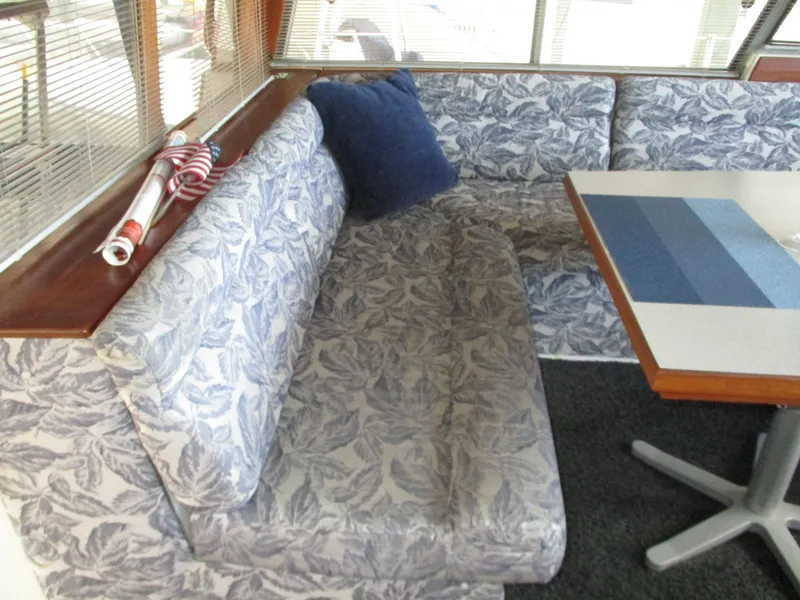 Slide: The Image of 1989 Bayliner 3888 interior with floral upholstery and a striped table. - 23