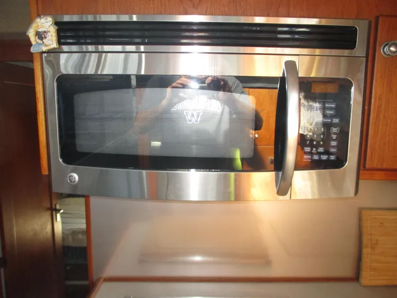 Slide: The Image of Stainless steel microwave in a 1989 Bayliner 3888 yacht kitchen. - 28