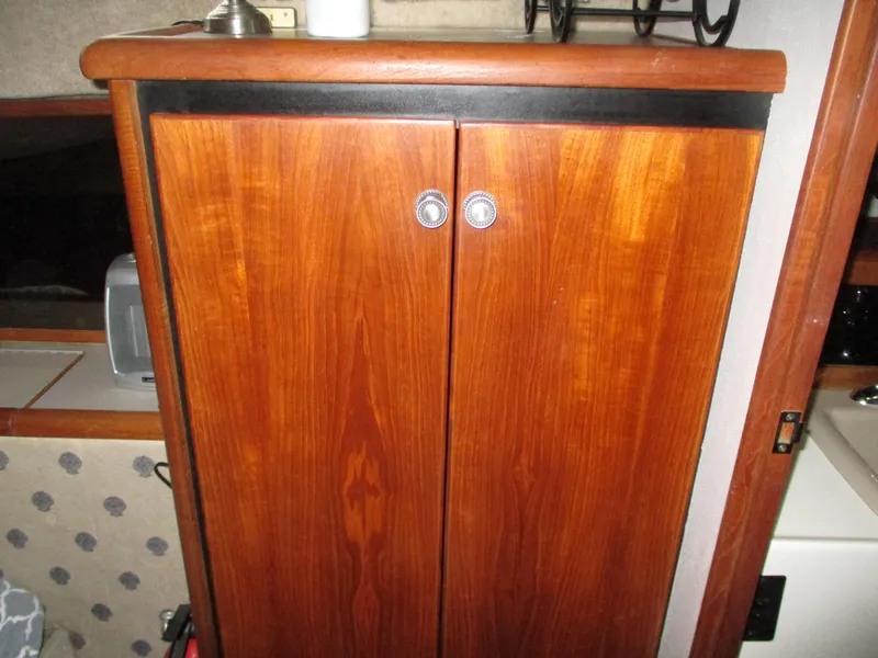 Slide: The Image of Wooden cabinet inside 1989 Bayliner 3888 boat, featuring polished handles. - 30