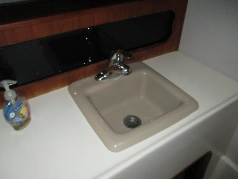 Slide: The Image of Sink area on 1989 Bayliner 3888 boat with faucet and soap dispenser. - 32
