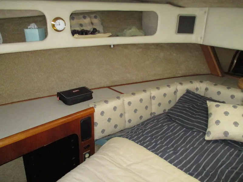 Slide: The Image of Cozy cabin interior of 1989 Bayliner 3888 with striped bedding and polka dot cushions. - 35