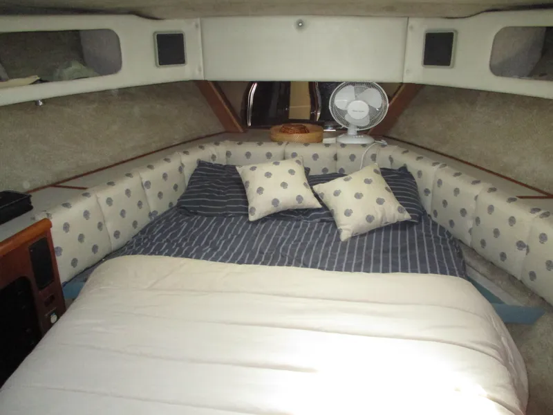 Slide: The Image of Cozy cabin interior of 1989 Bayliner 3888 with striped bedding and polka dot cushions. - 36
