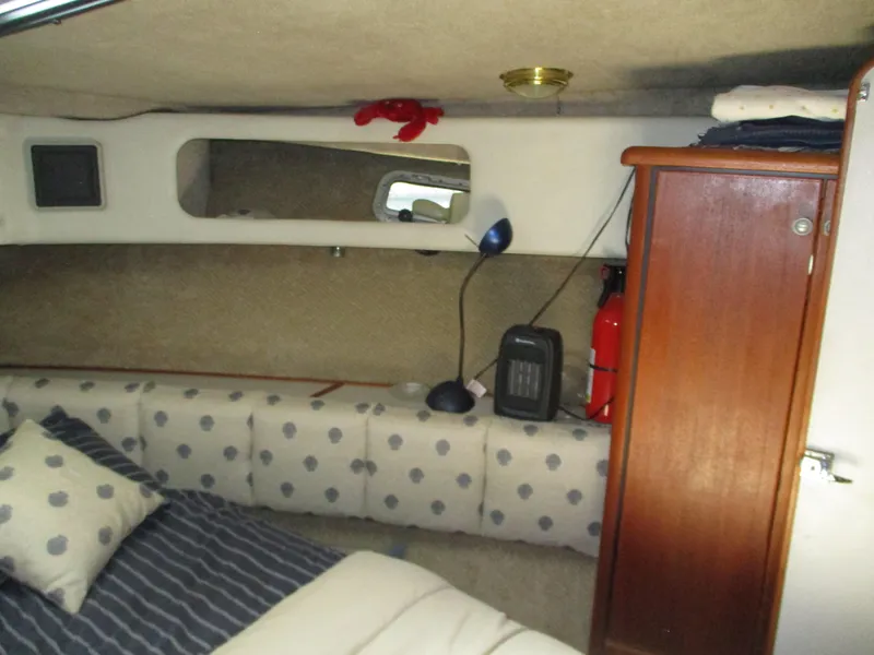 Slide: The Image of Interior cabin of 1989 Bayliner 3888 with polka dot cushions and wooden cabinet. - 37