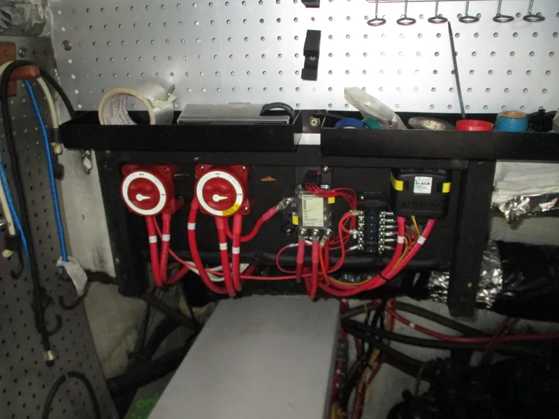 Slide: The Image of Electrical panel with red wiring in a 1989 Bayliner 3888 boat. - 41