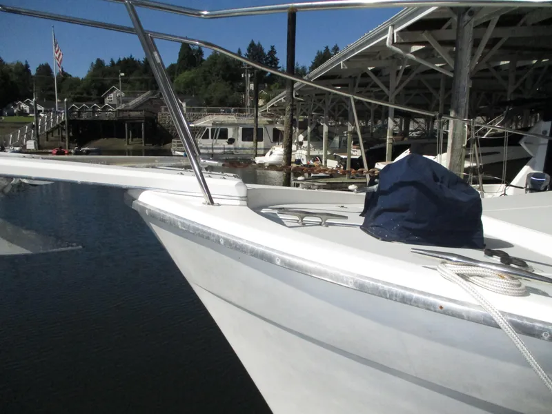 Slide: The Image of 1989 Bayliner 3888 yacht docked at marina with scenic background. - 5