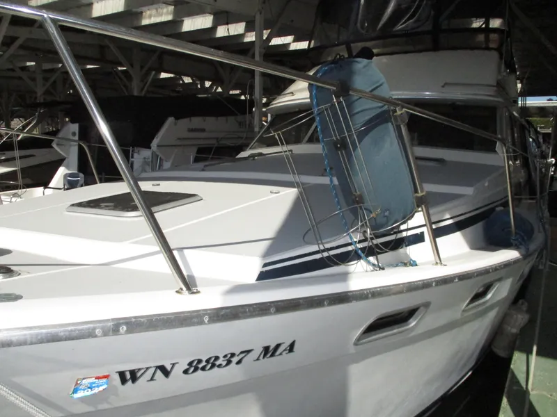 Slide: The Image of 1989 Bayliner 3888 boat docked in a marina, featuring a sleek white exterior. - 6