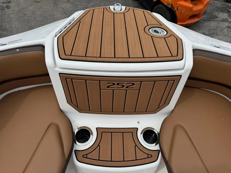 Slide: The Image of 2025 Yamaha Boats 252SD interior with wood finish and cup holders. - 12
