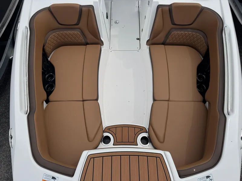 Slide: The Image of 2025 Yamaha Boats 252SD interior with tan seating and cup holders. - 14