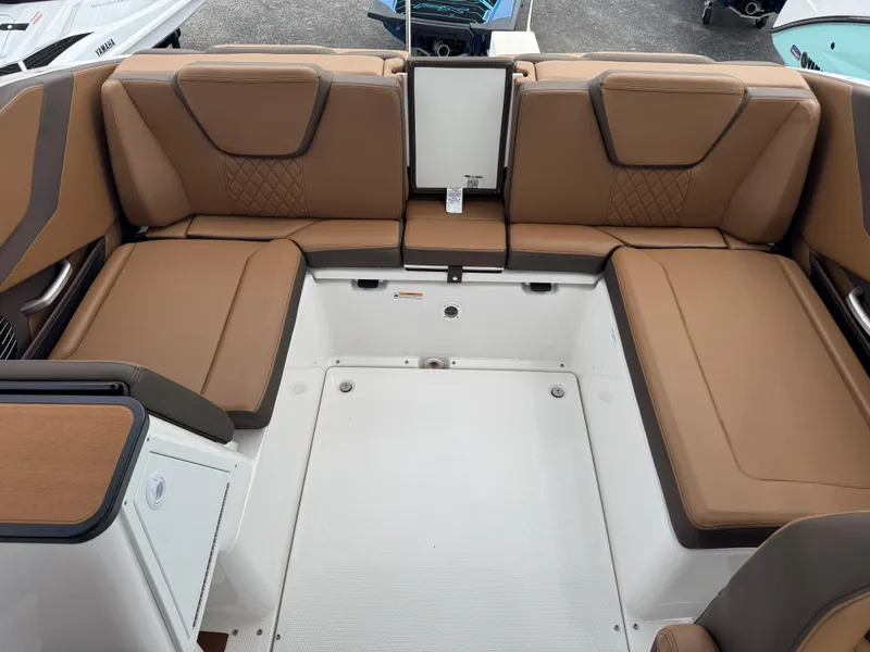 Slide: The Image of 2025 Yamaha Boats 252SD interior with brown cushioned seating and modern design. - 20