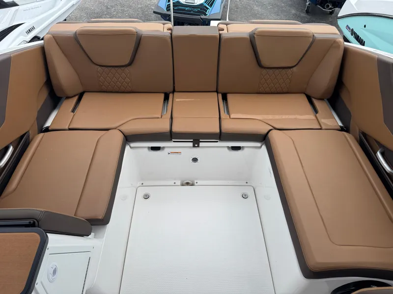 Slide: The Image of 2025 Yamaha Boats 252SD interior with brown cushioned seating and modern design. - 21