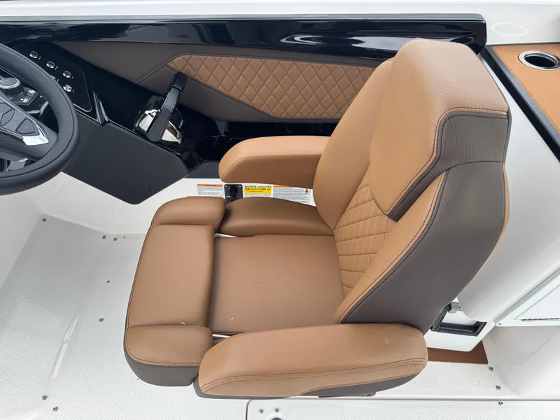 Slide: The Image of 2025 Yamaha Boats 252SD captain's seat with tan upholstery and diamond stitching. - 23