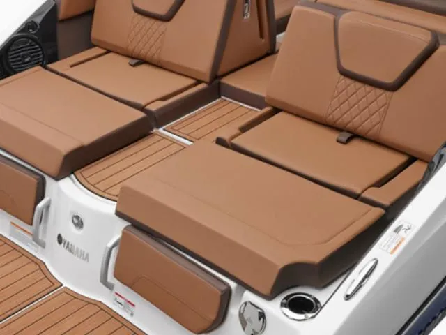Slide: The Image of 2025 Yamaha Boats 252SD interior with brown cushioned seating and teak-style flooring. - 34