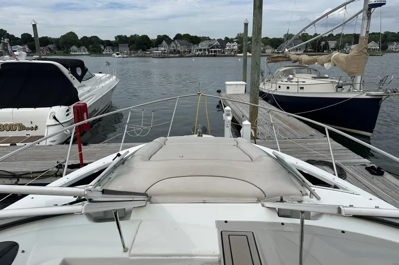 Slide: The Image of 2002 Doral 330se boat docked at marina with other boats and waterfront homes. - 11