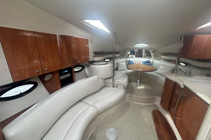 Slide: The Image of Luxurious interior of a 2002 Doral 330se yacht with plush seating and wooden cabinetry. - 13