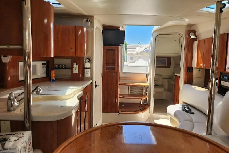 Slide: The Image of Interior of a 2002 Doral 330se yacht with wood cabinetry and modern amenities. - 14