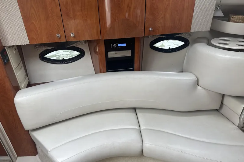 Slide: The Image of Interior of 2002 Doral 330se boat with white leather seating and wood cabinetry. - 15