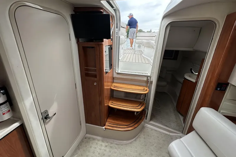 Slide: The Image of Interior of 2002 Doral 330se yacht with wooden steps and compact design. - 19