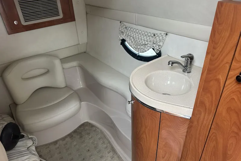 Slide: The Image of 2002 Doral 330se cabin interior with sink, seating, and wood accents. - 20