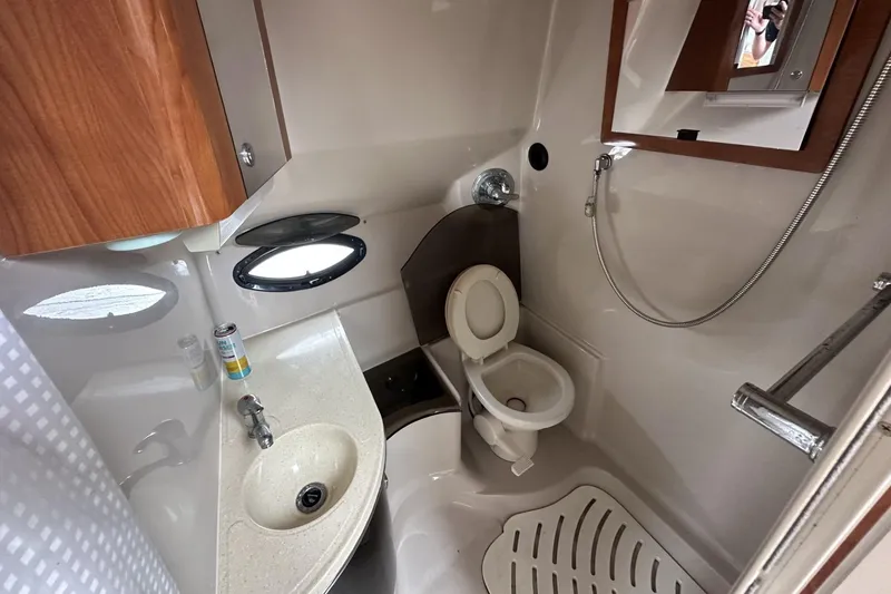Slide: The Image of Bathroom interior of a 2002 Doral 330se boat with sink, toilet, and shower. - 22