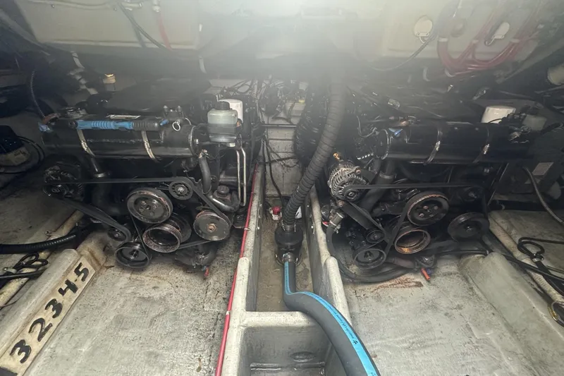 Slide: The Image of Engine compartment of a 2002 Doral 330se boat, showcasing dual engines and mechanical components. - 23