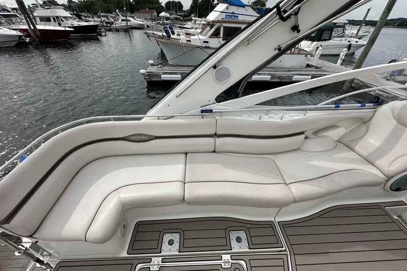 Slide: The Image of Luxury seating on a 2002 Doral 330se boat docked at a marina. - 5