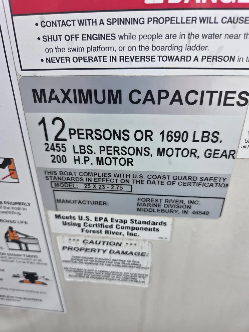 Slide: The Image of 2017 South Bay 523 CR capacity label: 12 persons, 1690 lbs, 200 HP motor. - 11