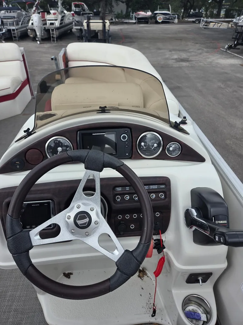 Slide: The Image of 2017 South Bay 523 CR boat dashboard with steering wheel and control panel. - 12