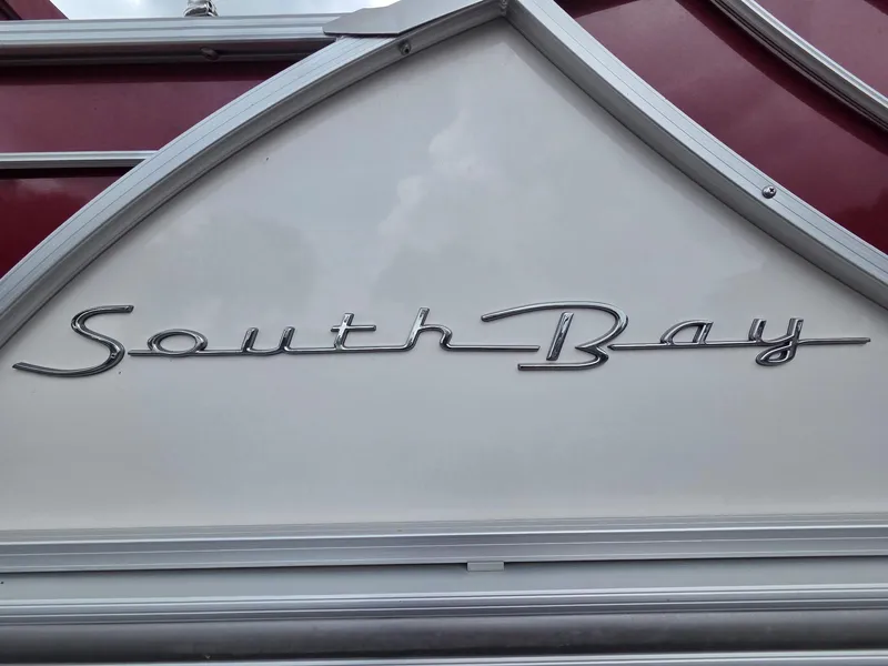 Slide: The Image of 2017 South Bay 523 CR logo on boat exterior, featuring elegant silver script. - 9