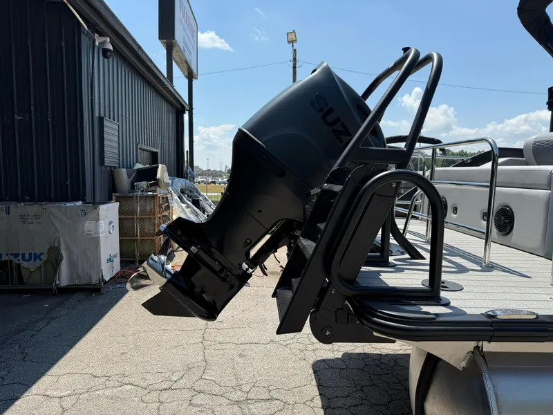 Slide: The Image of 2026 Bentley Pontoons Elite 253 Swingback with Suzuki outboard motor, docked outdoors. - 14