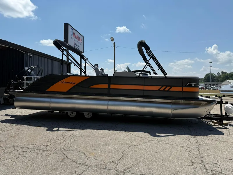 Slide: The Image of 2026 Bentley Pontoons Elite 253 Swingback, sleek design, parked outdoors under a clear sky. - 2