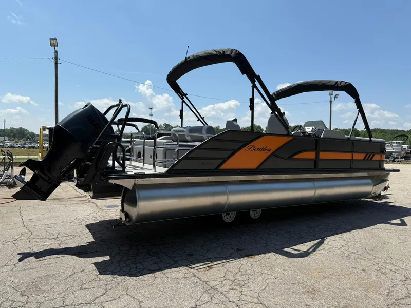 Slide: The Image of 2026 Bentley Pontoons Elite 253 Swingback on display, featuring sleek design and powerful outboard motor. - 3