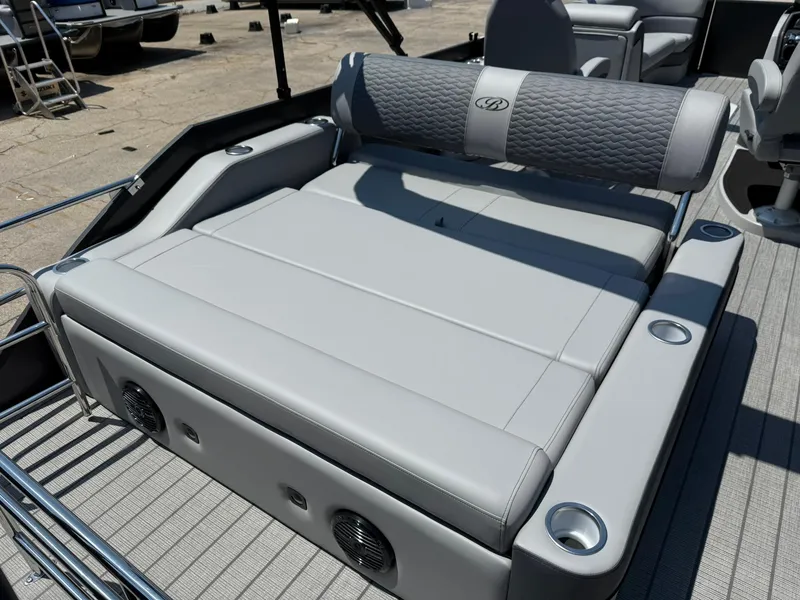 Slide: The Image of 2026 Bentley Pontoons Elite 253 Swingback with luxurious seating and integrated speakers. - 7