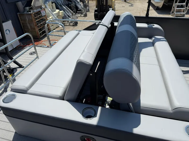 Slide: The Image of 2026 Bentley Pontoons Elite 253 Swingback with luxurious gray seating and cup holders. - 8