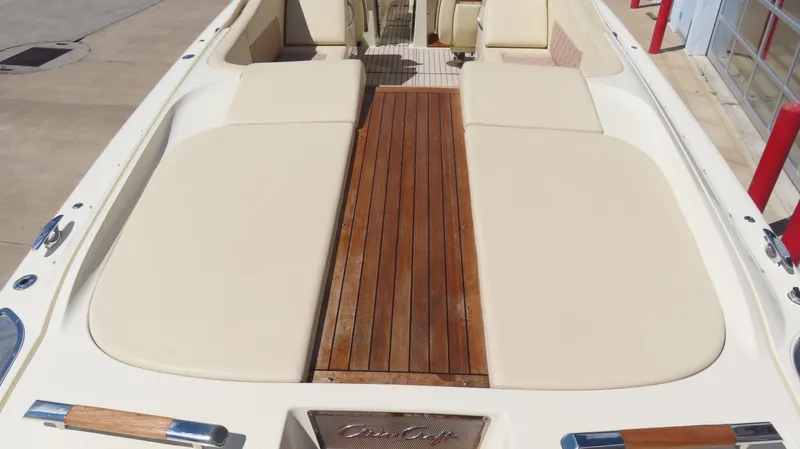 Slide: The Image of 2018 Chris-Craft Launch 34 boat with teak deck and beige seating. - 13