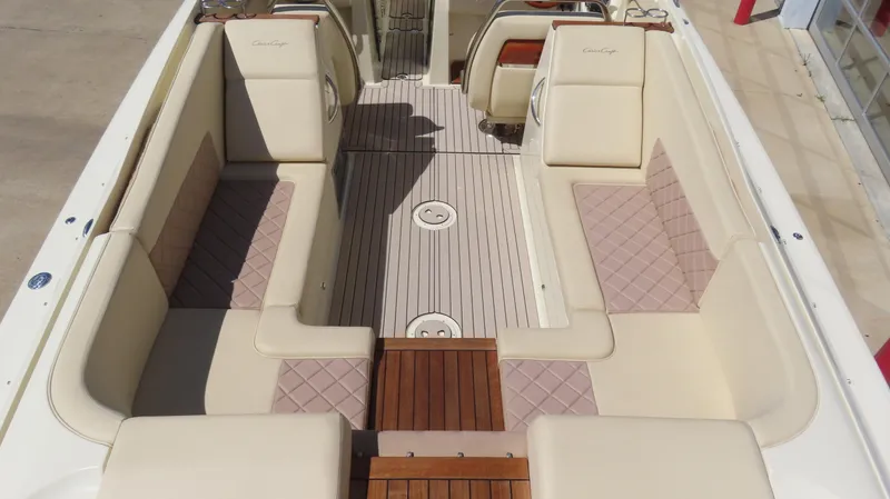 Slide: The Image of 2018 Chris-Craft Launch 34 interior with beige seating and wooden flooring. - 15