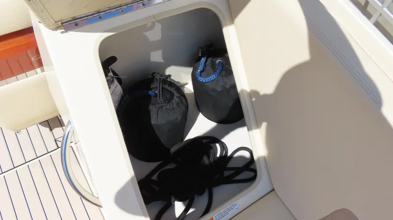 Slide: The Image of Storage compartment on 2018 Chris-Craft Launch 34 boat with ropes and bags. - 17