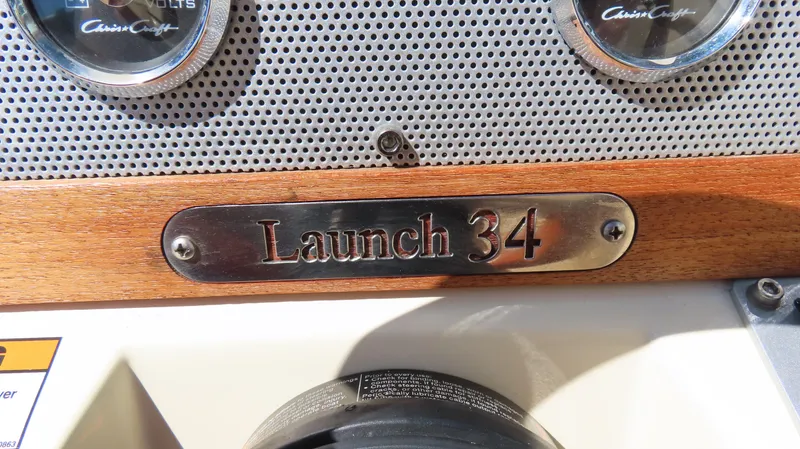 Slide: The Image of 2018 Chris-Craft Launch 34 dashboard with nameplate and gauges. - 18