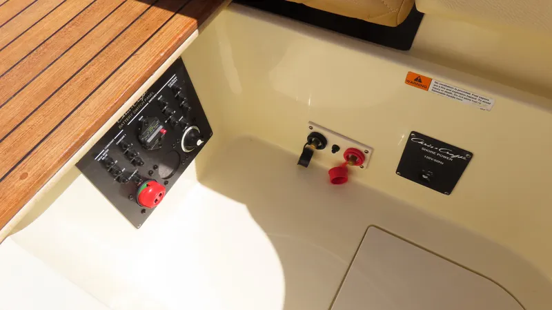 Slide: The Image of 2018 Chris-Craft Launch 34 control panel with wooden trim and power switches. - 26