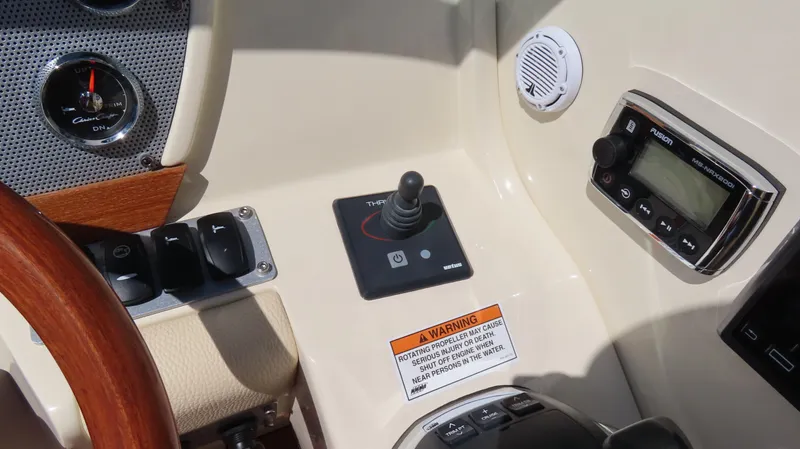 Slide: The Image of 2018 Chris-Craft Launch 34 dashboard with controls, gauges, and warning label. - 28