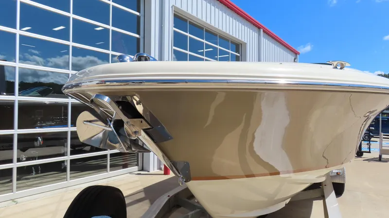 Slide: The Image of 2018 Chris-Craft Launch 34 boat on trailer, parked outside a modern building. - 3