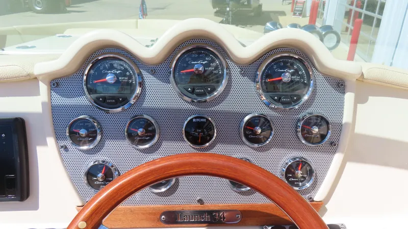Slide: The Image of Dashboard of 2018 Chris-Craft Launch 34 with gauges and wooden steering wheel. - 30