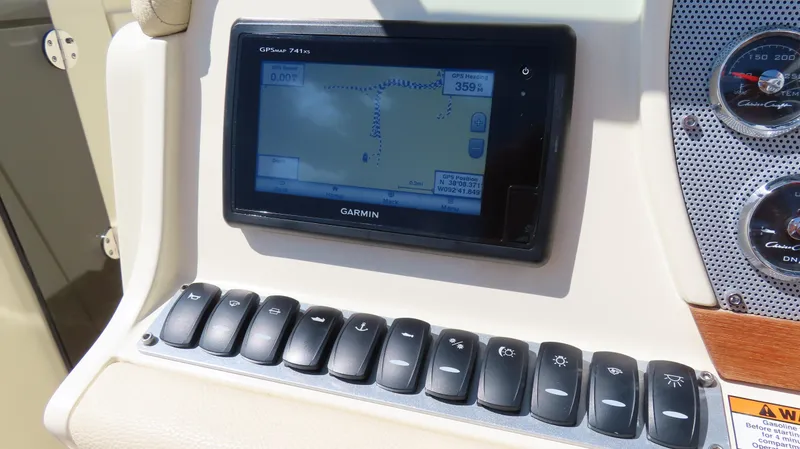 Slide: The Image of Control panel of 2018 Chris-Craft Launch 34 with Garmin GPS and switches. - 32