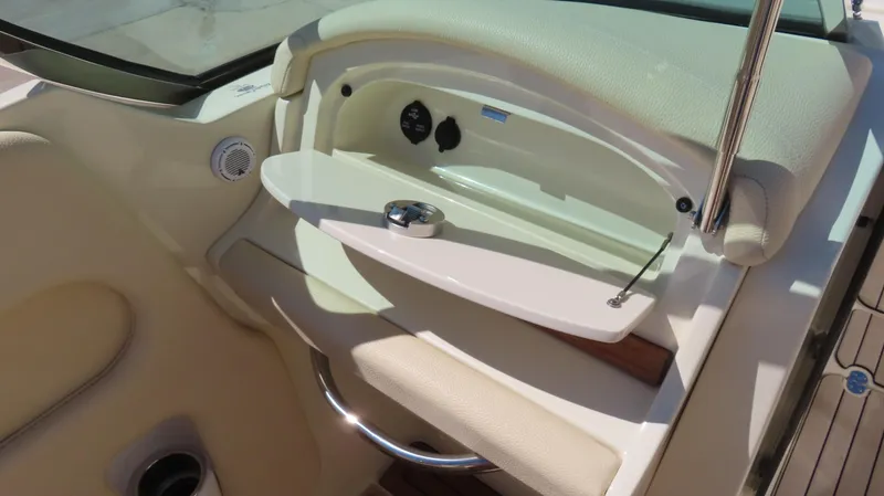 Slide: The Image of 2018 Chris-Craft Launch 34 interior detail with beige upholstery and storage compartment. - 33